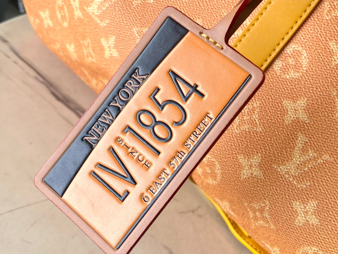 LOUIS VUITTON KEEPALL BANDOULIÈRE 55 IN ORANGE MONOGRAM HERITAGE CANVAS